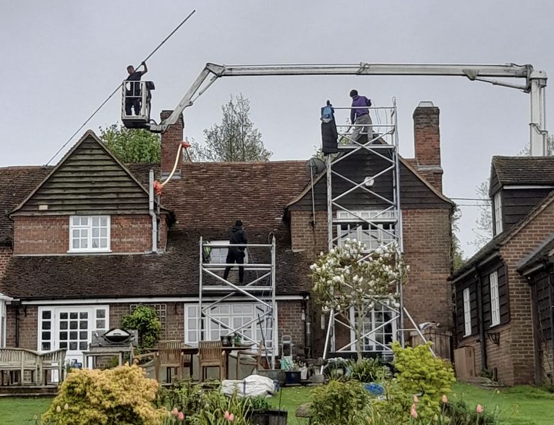 The Roof Moss Cleaners using cherry picker and scaffolding to clean roof safely and professionally in Banbury, Oxfordshire